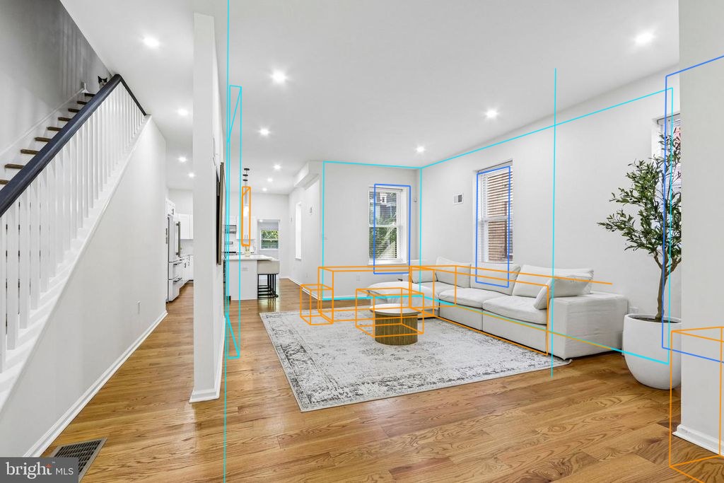 Photo 4 — Living room, from the entry with the plan's walls, windows and furniture projected through the fitted camera