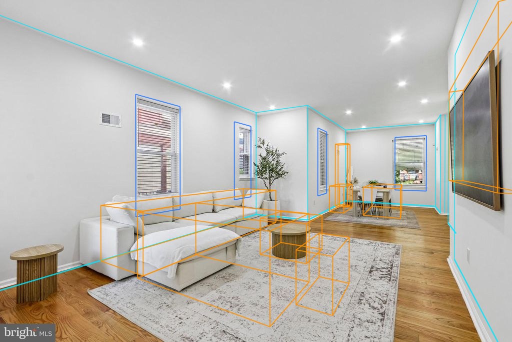 Photo 7 — Living room toward dining with the plan's walls, windows and furniture projected through the fitted camera